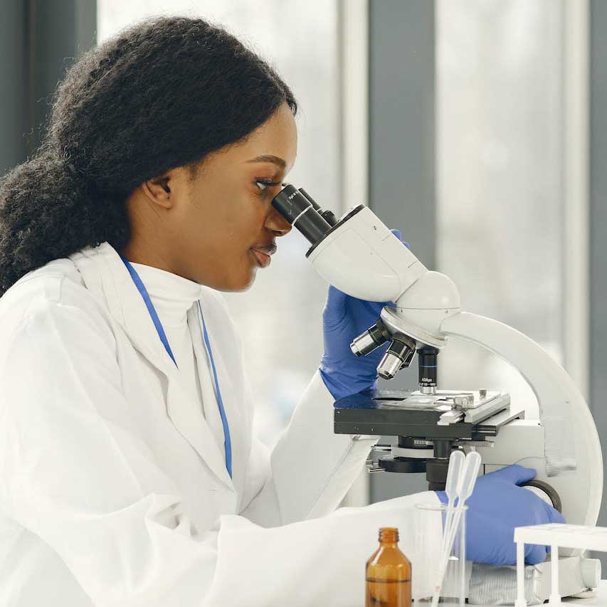 Scientist using a microscope in a laboratory